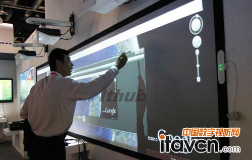 2011北京INFOCOMM展中，工作人員正在演示使用4.5米超大大屏幕融合電子白板